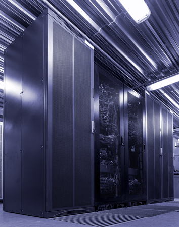 Rack server hardware in big data center with connected cables and wires black and white toningの写真素材