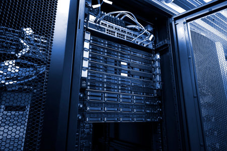 Blade server in mounted rack cluster hard drives storage tapes with optic cables internet wires in...