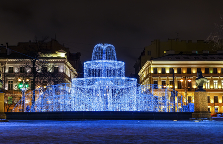 Winter holidays. Street Christmas decorations in the evening. Admiralty building, Winter fountain of hundreds of small lights in the Alexander Gardenの写真素材