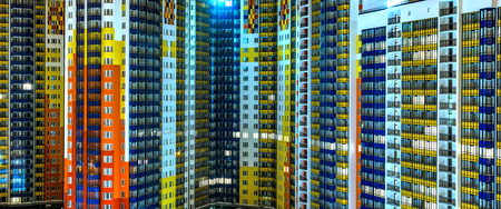 facade of residential apartments in a modern metropolis. Night, background textureの写真素材