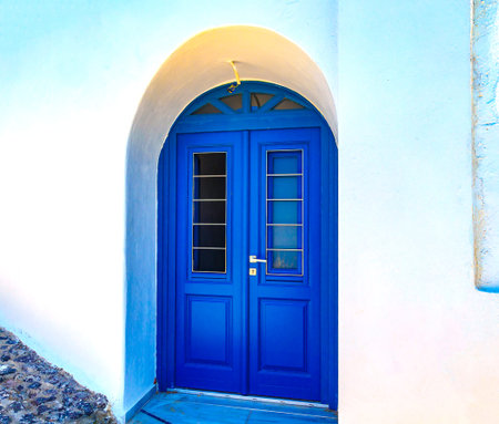 Blue door on a whitewashed wall - Santorini island, Greece
