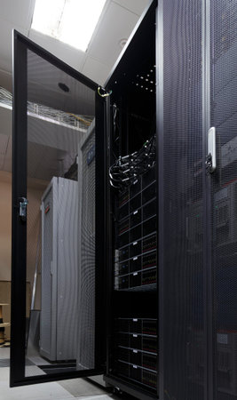 Server rack in big data center inside close up. Supercomputer with hardware, storage blades, cables...