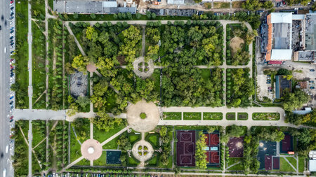 Aerial shot of beautiful metropolitan Park with tree paths, sports grounds