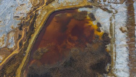 lake with red-orange water, traces of pollution from the plant, ecological disaster Karabash, Chelyabinsk region, Ural.の写真素材