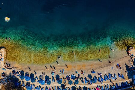 beach of the Greek island of Simi with rocks and clear water view from droneの写真素材