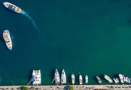 Aerial drone birds eye top view of white traditional fishing boat in turquoise clear waters, Simy, Greeceの写真素材