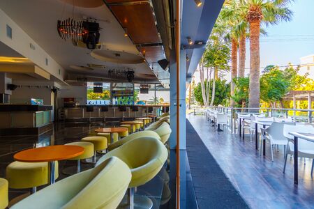lounge bar of modern European resort hotel, interior with terrace, tables, lighting. Rhodes, Greeceの写真素材