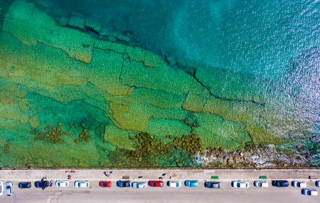 stone slabs at the bottom of the clear sea at the waterfront of the port of Rhodes, Greece