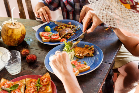 hands of a woman and a man on the table at Breakfast healthy food close-up. Concept of healthy...