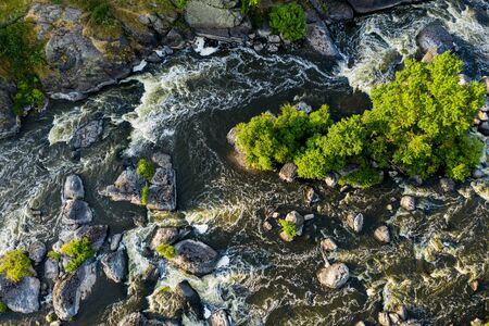 Many rapids with waterfalls, spray foam and whirlpools close-up, rotate the camera. View from a drone. Ural region, Russia. The threshold Revunの写真素材