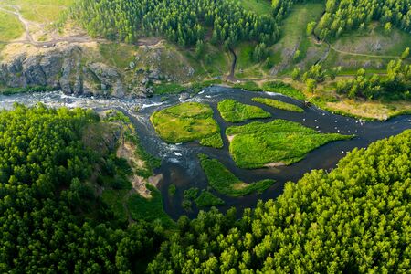 cascade of streams with Islands, green forests and grass, top view from drone, picturesque nature with a mountain river in the forest.の写真素材