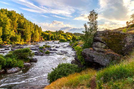 Ural Mountains. Rocks and rocky rifts on a mountain river in summer. View on valley and the river Iset with rocky banks.の写真素材