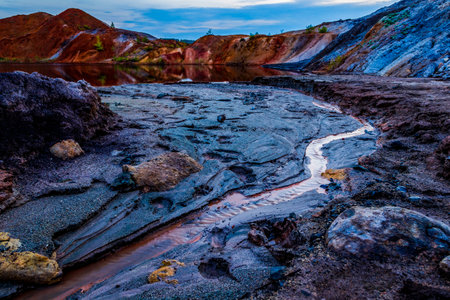 Ural Apocalyptic Surreal unusual landscape, similar to the surface of the planet Mars. Frozen red-brown surface of Chernozem. Barren, cracked and scorched earth and soil. The concept of global warming. Refractory clay quarries. Textured background.の写真素材