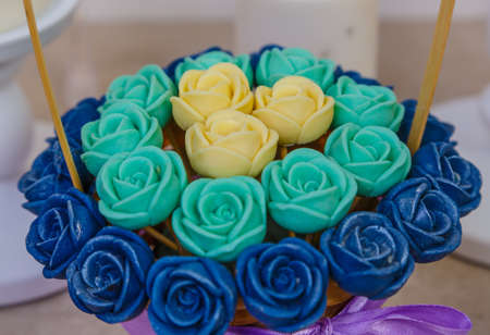 hatbox with bouquet of chocolate roses standing in the fireplace among candles.の写真素材