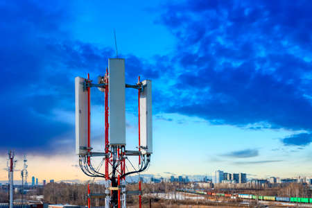 cellular antenna on the background of sunset clouds, concept of mobile communication and information technologyの写真素材