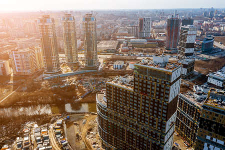 Modern city houses with red roofs in rays sun. Clip. Top view of urban residential high rise buildings with red roofs.の写真素材