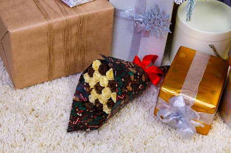 edible chocolate flowers, bouquet of roses among bright gift boxesの写真素材
