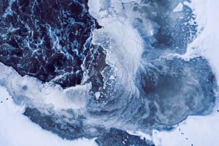 The holes in ice through which are visible the algaeの写真素材