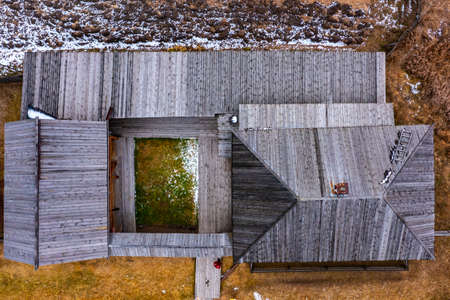 wooden village house in Russia of the 19th century, outbuildings and yard with tools, a view vertically down from drone.の写真素材