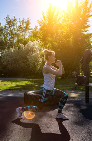 Healthy young woman warming up stretching her arms outdoor. People runner workout before fitness and jogging session workout in park. Healthy and Lifestyle Concept.の写真素材