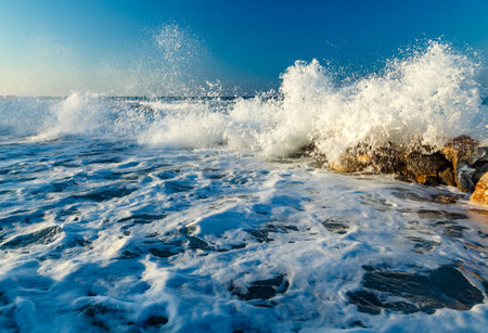Beautiful Sea Landscape with Waves Breaking on a Sandy and Rocky Beach. Waves on Background. Summer time in Rhodes, Greece. rocks on the coast of blue sea on a sunny summer dayの写真素材