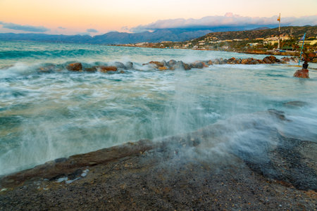 Rocks on the Coast Of Cretan Sea near Hersonissos, Crete, Greece. Aegean Sea with wawes and clouds.の写真素材