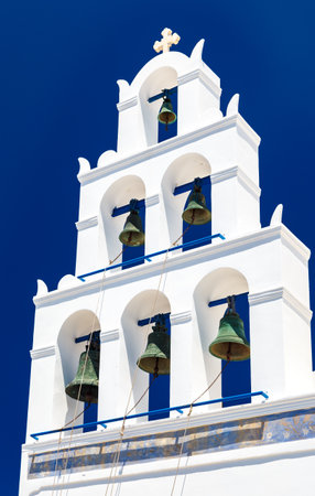 Unique bell tower of a small church in Oia, Santorini island, Greeceの写真素材