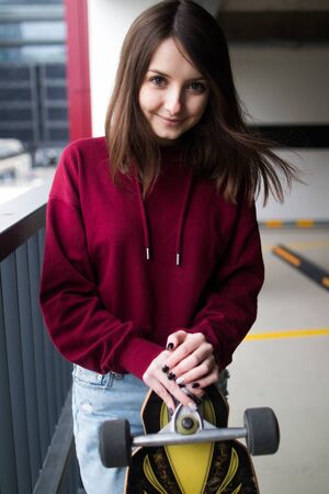 big eyes, sweet girl in burgundy hoodie, smiling and looking at youの写真素材