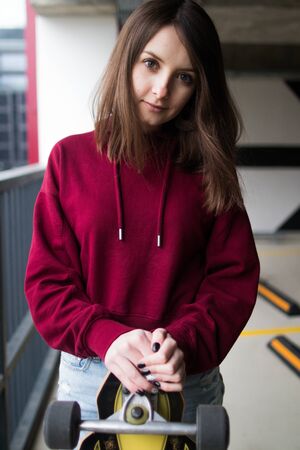 big eyes, sweet girl in burgundy hoodie, smiling and looking at youの写真素材