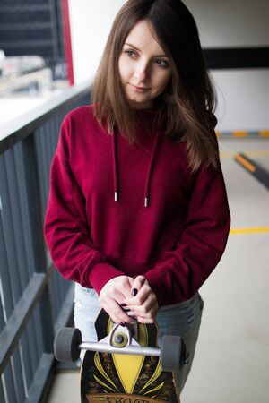 big eyes, sweet girl in burgundy hoodie, smiling and looking at youの写真素材
