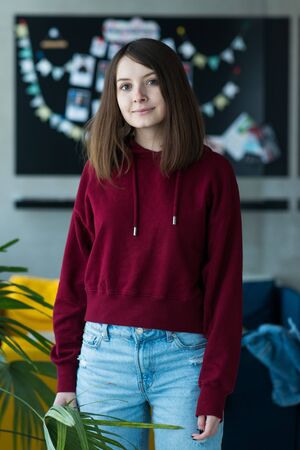 big eyes, sweet girl in burgundy hoodie, smiling and looking at youの写真素材