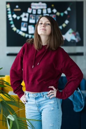 big eyes, sweet girl in burgundy hoodie, smiling and looking at youの写真素材