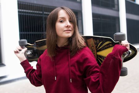 big eyes, sweet girl in burgundy hoodie, smiling and looking at youの写真素材