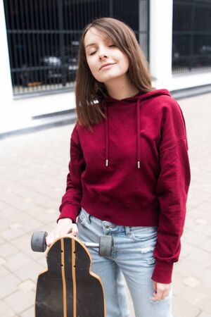 big eyes, sweet girl in burgundy hoodie, smiling and looking at youの写真素材