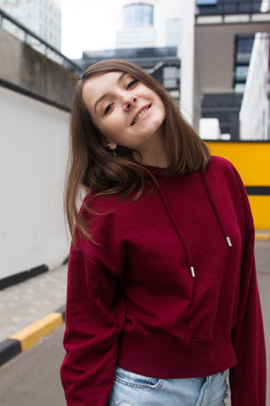 big eyes, sweet girl in burgundy hoodie, smiling and looking at you