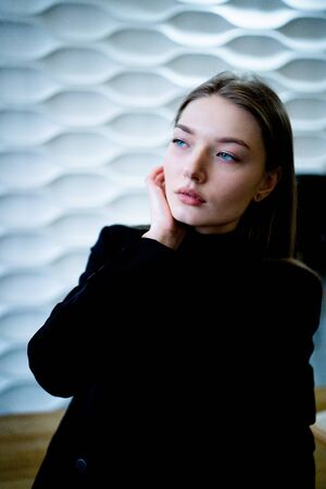 Business woman standing near the table in a black jacketの写真素材