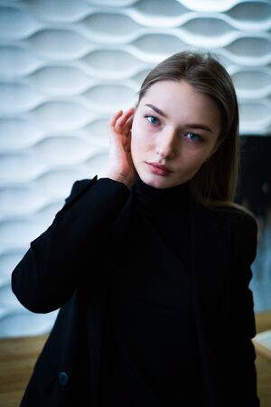 Business woman standing near the table in a black jacketの写真素材
