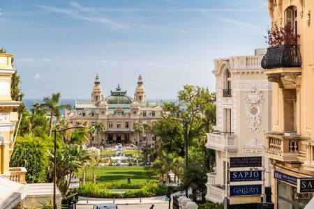 Monaco, Monte-Carlo, 02 October 2019: The main sight of the principality casino surrounded with the green trees, the updated facade, through the fountain, hotel the Paris, sunny dayのeditorial素材