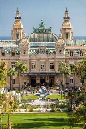 Monaco, Monte-Carlo, 02 October 2019: The main sight of the principality casino surrounded with the green trees, the updated facade, through the fountain, hotel the Paris, sunny dayのeditorial素材