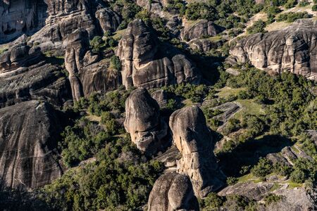 Aerial view of monument Meteora, the mountains, the landmark of Greek, sunny weather, fog, haze over a valleyの写真素材