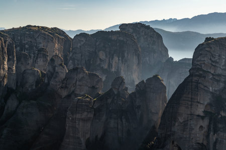 Aerial view of monument Meteora, the mountains, the landmark of Greek, sunny weather, fog, haze over...