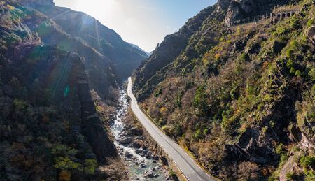 The mountain river along the Road, Aerial panoramic drone view of a scenic highway by the beautiful Landscape covered in clouds and fog, bridge and viaduct, The mountain river along the road,の写真素材