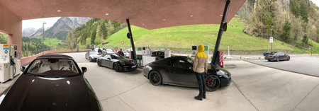 Italy, 28 April 2019: Some black sports cars refuel at gas station somewhere on serpentines in the...