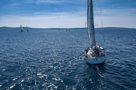 Aerial shot of the yacht race, a sailing regatta, intense competition, a lot of white sails, island is on background, top travel destination, vacation in Croatia, idyllic landscapeのeditorial素材