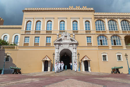 Monaco, Old Town, 27 September 2019: The palace of the prince of Monaco, guard in white uniform, guns, facade of royal castle, square in front of the palace, sunny dayのeditorial素材