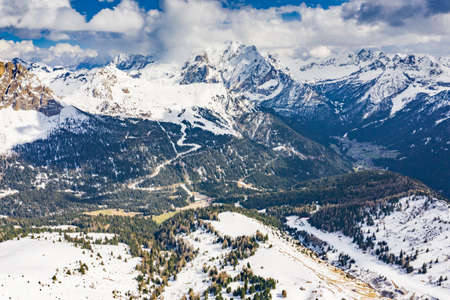 Aerial view of twisting road in the mountains of Italy, is serpentine among the snow-covered hills, is famous place among skiers and fans to understand a known by sports carsの写真素材