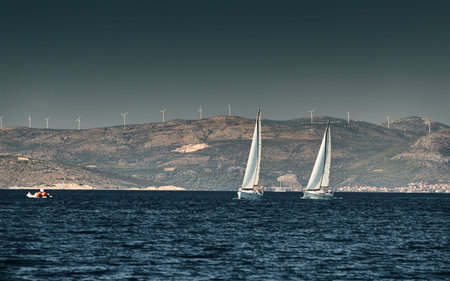 The race of sailboats, a regatta, reflection of sails on water, Intense competition, number of boat...