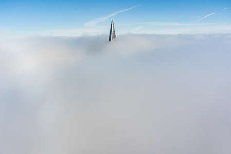 Russia, St. Petersburg, 14 October 2021: The top of the tallest skyscraper in Europe above the clouds, the building of the Gazprom oil company, the spire of a metal and glass structureのeditorial素材