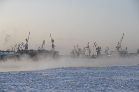 The construction of nuclear icebreakers, cranes of of the Baltic shipyard in a frosty winter day,...