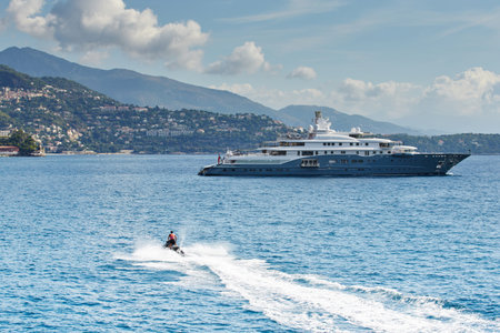 Monaco, Monte-Carlo, most expensive mega yacht on sea, sunny day, Jet Ski, mountains on background